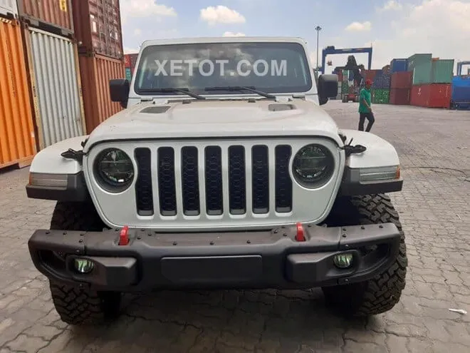 Xe Jeep Gladiator Rubicon màu đỏ đang thể hiện khả năng off-road trên đường đất